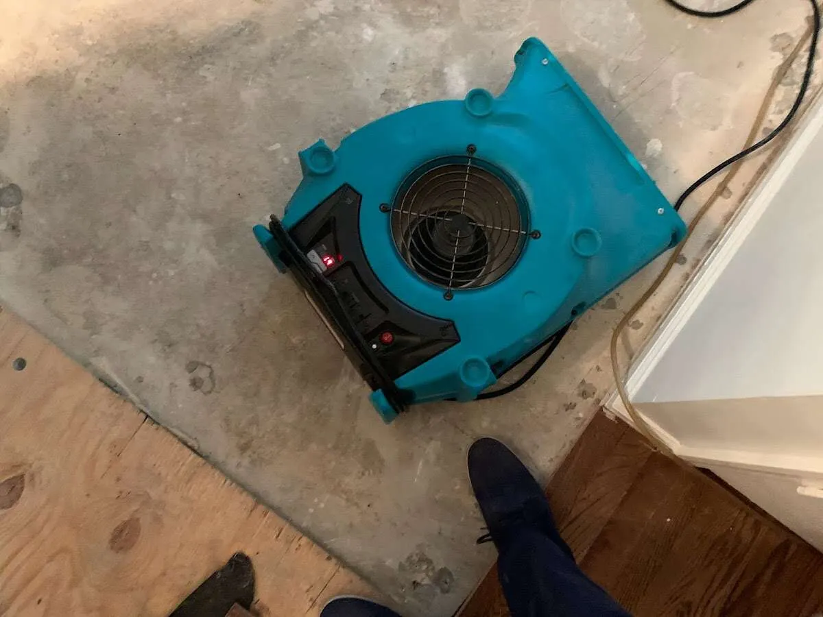 Air mover drying subfloor during Commercial Water Damage Restoration in Selah